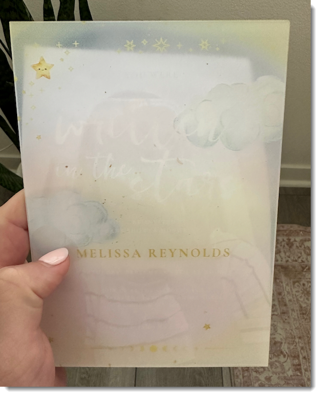 Acrylic invitation with white text on a non-contrasting background. 